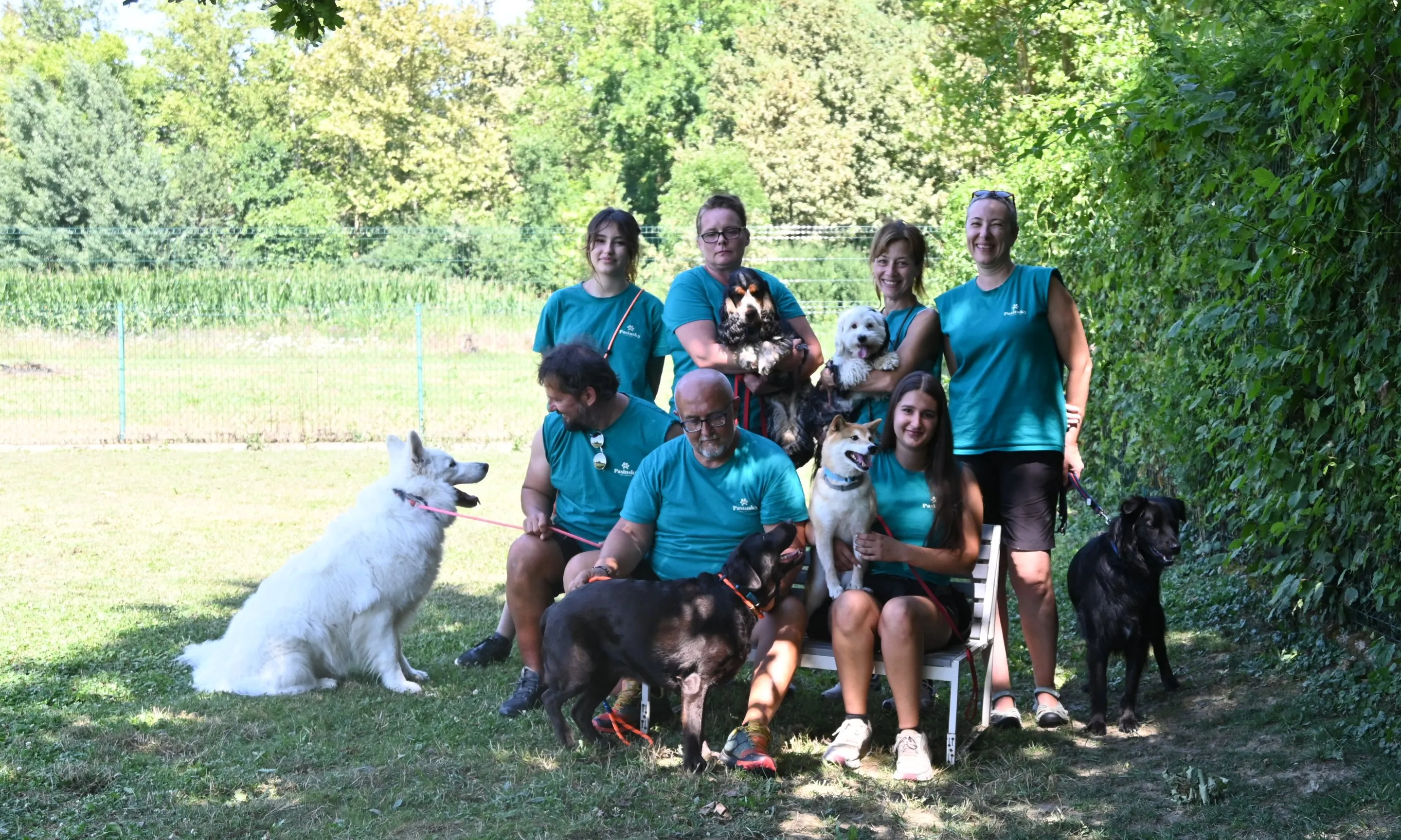 The Pasinsky team in front of the dog hotel and daycare sign