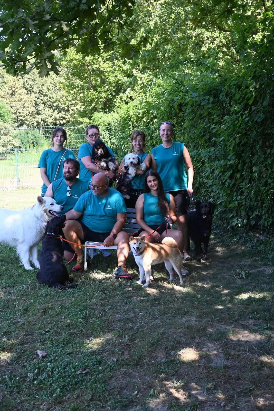 The Pasinsky team in front of the dog hotel and daycare sign